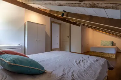 a bedroom with a bed with a blue pillow at Hakuna Matata Apartments in Ulcinj