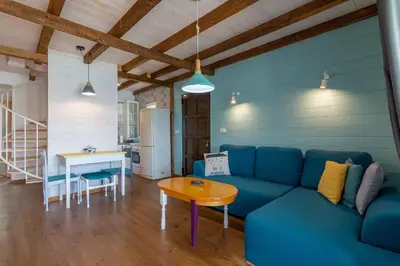 a living room with a blue couch and a table at Hakuna Matata Apartments in Ulcinj