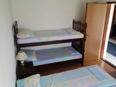 two bunk beds in a room with a door at Apartman Tripkovic in Bar