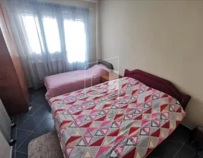 a bedroom with a bed in a room with a window at Apartment Podgorica centre in Podgorica