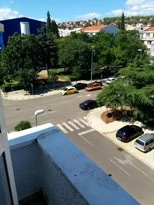 a view of a parking lot with cars on a street at Apartment Podgorica centre in Podgorica