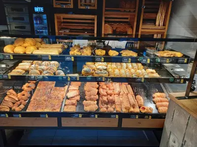 a display case in a bakery filled with lots of pastries at Apartment Podgorica centre in Podgorica