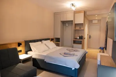 a hotel room with a bed and a couch at Sea Star Apartments in Ulcinj