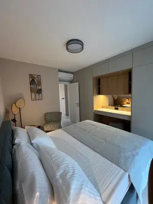a bedroom with a large bed and a kitchen at Sea Star Apartments in Ulcinj