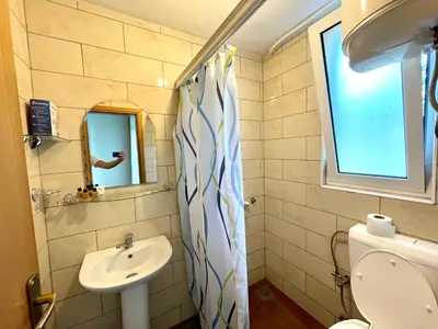 a bathroom with a sink and a toilet and a mirror at Apartments Flamingo in Ulcinj