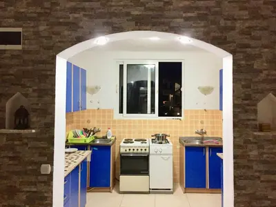 a kitchen with blue cabinets and a white stove at Apartments Flamingo in Ulcinj