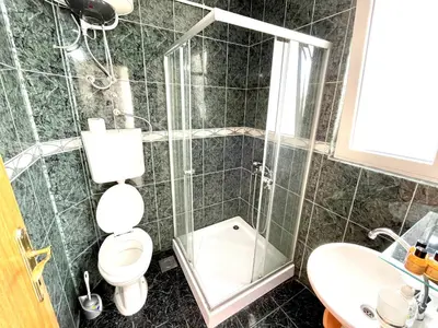 a bathroom with a shower and a toilet and a sink at Apartments Flamingo in Ulcinj