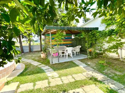 a gazebo with a table and chairs in a yard at Apartments Flamingo in Ulcinj
