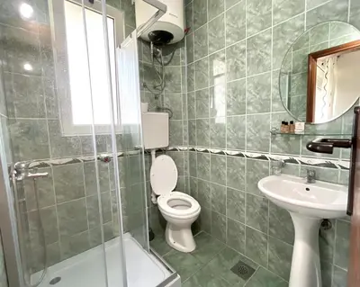 a bathroom with a toilet and a sink at Apartments Flamingo in Ulcinj
