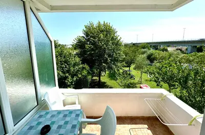 a balcony with a table and a view of a bridge at Apartments Flamingo in Ulcinj