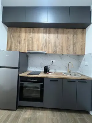 a kitchen with a sink and a refrigerator at Azzure Apartment in Ulcinj