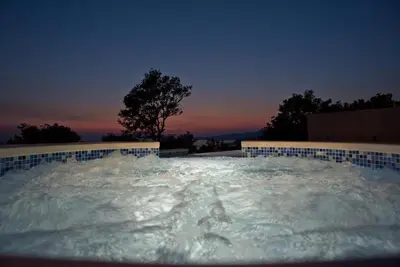 a jacuzzi tub filled with water at night at Luxury Villa Crystal Blue in Sveti Stefan