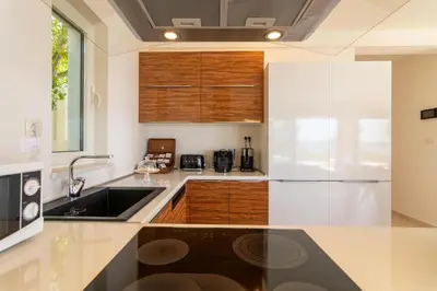 a kitchen with a sink and a refrigerator at Luxury Villa Crystal Blue in Sveti Stefan