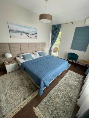 a bedroom with a bed with a blue comforter at Luxury Villa Crystal Blue in Sveti Stefan