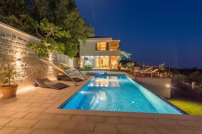 a swimming pool in the backyard of a house at Luxury Villa Crystal Blue in Sveti Stefan