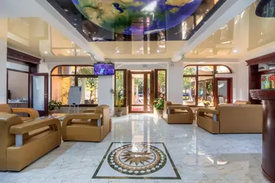 a lobby with couches and a tv on a ceiling at Hotel Pharos in Bar
