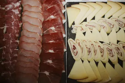 a display of meats and cheese on a table at Hotel Pharos in Bar