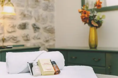 a pile of products sitting on top of a bed at D & Sons Apartments in Kotor