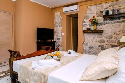 a bedroom with a bed with a tray of food on it at D & Sons Apartments in Kotor