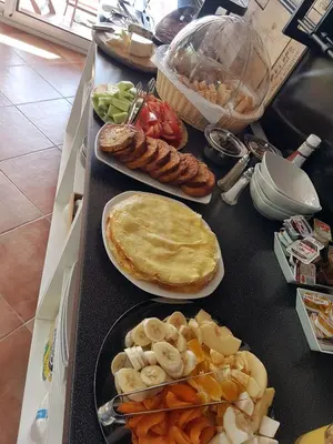 a table topped with plates of food with pies and vegetables at Adriatic Apartment in Ulcinj