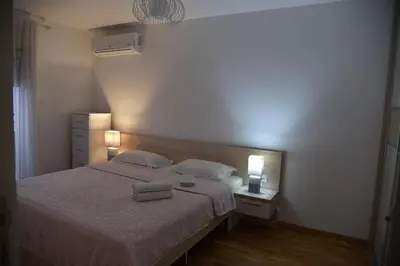 a bedroom with a bed with two towels on it at Apartment Lux Fontana in Budva