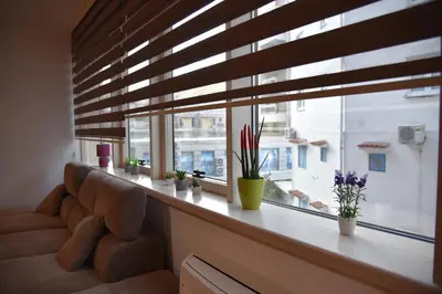 a window sill with a couch and plants on it at Apartment Lux Fontana in Budva