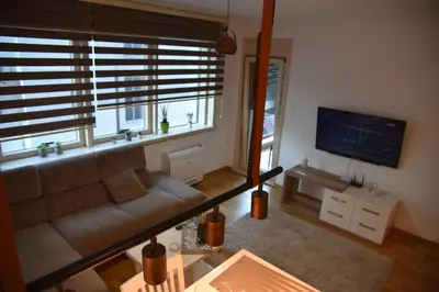 a living room with a couch and a large window at Apartment Lux Fontana in Budva