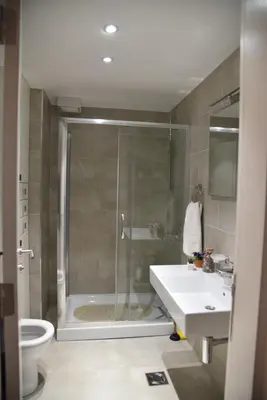 a bathroom with a shower and a sink and a toilet at Apartment Lux Fontana in Budva