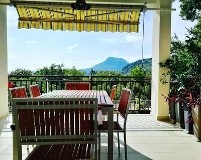 a table and chairs on a balcony with a view at Villa Marko in Sutomore