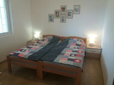 a bedroom with a bed with a quilt on it at Villa Marko in Sutomore