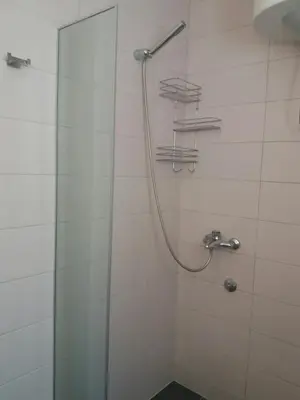 a shower with a shower head in a bathroom at Villa Marko in Sutomore