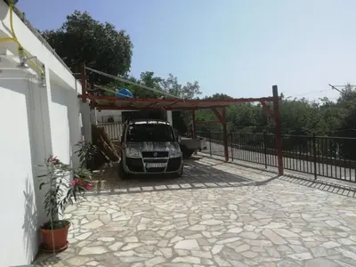 a car parked under a pergola in a driveway at Villa Marko in Sutomore