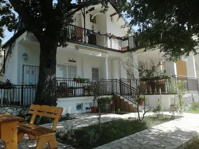 a wooden bench sitting in front of a building at Villa Marko in Sutomore