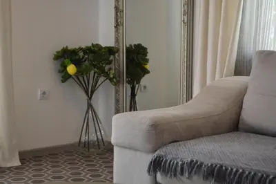 a living room with a couch and a mirror at Apartman L&M in Cetinje
