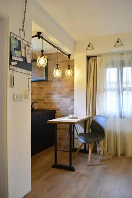 a dining room table and a chair in a kitchen at Apartman L&M in Cetinje