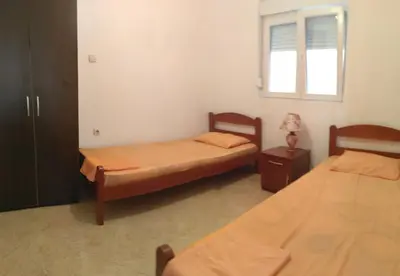 a bedroom with two beds and a window at Apartmani Vujicic in Bar