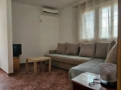 a living room with a couch and a table at Apartmani Vujicic in Bar