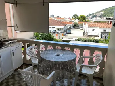 a table and chairs on a balcony with a view at Apartments Batalo in Budva