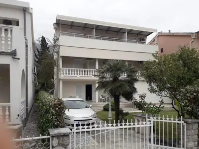 a white car parked in front of a house at Apartments Batalo in Budva