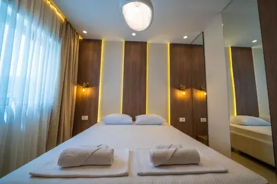 a bedroom with a large bed with towels on it at Apartments Stanaj in Ulcinj