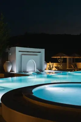 a swimming pool at night with blue lights at Apartments Stanaj in Ulcinj