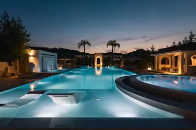 a large swimming pool at night with lights at Apartments Stanaj in Ulcinj
