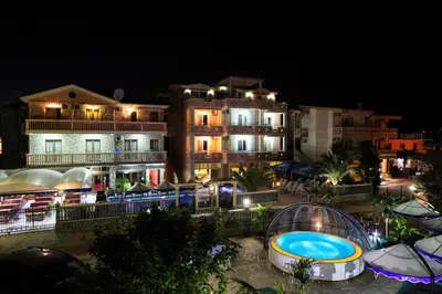 a resort with a swimming pool at night at Aparthotel Villa Primafila in Ulcinj