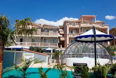 a view of a resort with a pool and an umbrella at Aparthotel Villa Primafila in Ulcinj