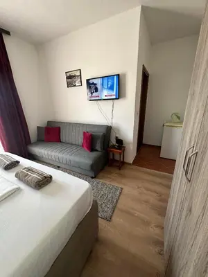 a living room with a bed and a couch at Rooms Ajllin in Ulcinj