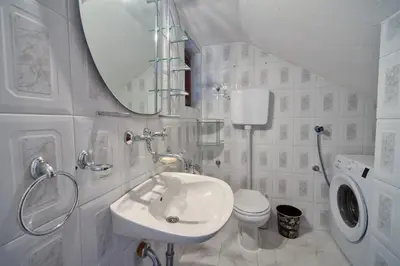 a bathroom with a sink and a toilet and a mirror at BOR - The Entire Home with Sea view in Ulcinj