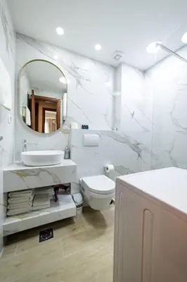 a bathroom with a sink and a toilet and a mirror at Apartments 28 in Podgorica
