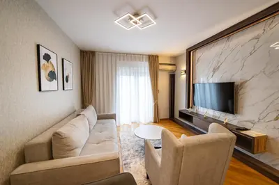 a living room with a couch and a tv at Apartments 28 in Podgorica