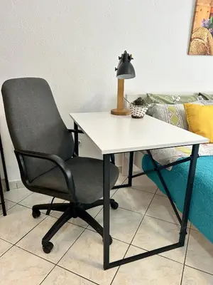 a white desk with a chair and a lamp at Studio Lucica in Petrovac na Moru