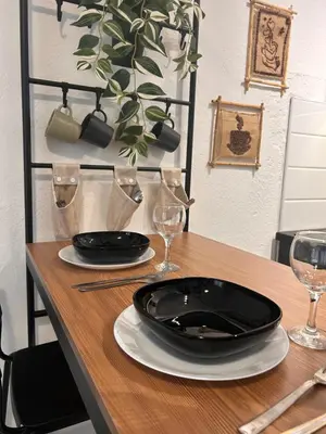 a table with two black plates and glasses on it at Studio Lucica in Petrovac na Moru